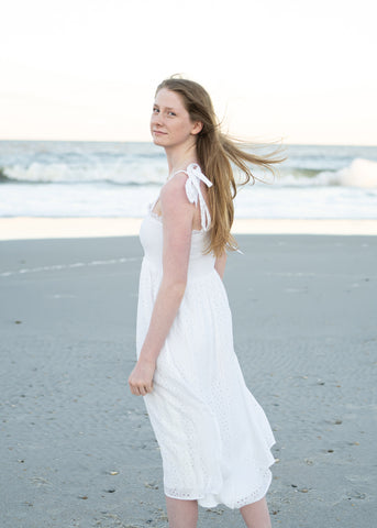Woman in white dress on beach