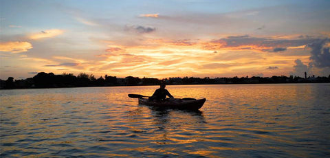 Person in kayak at sunset