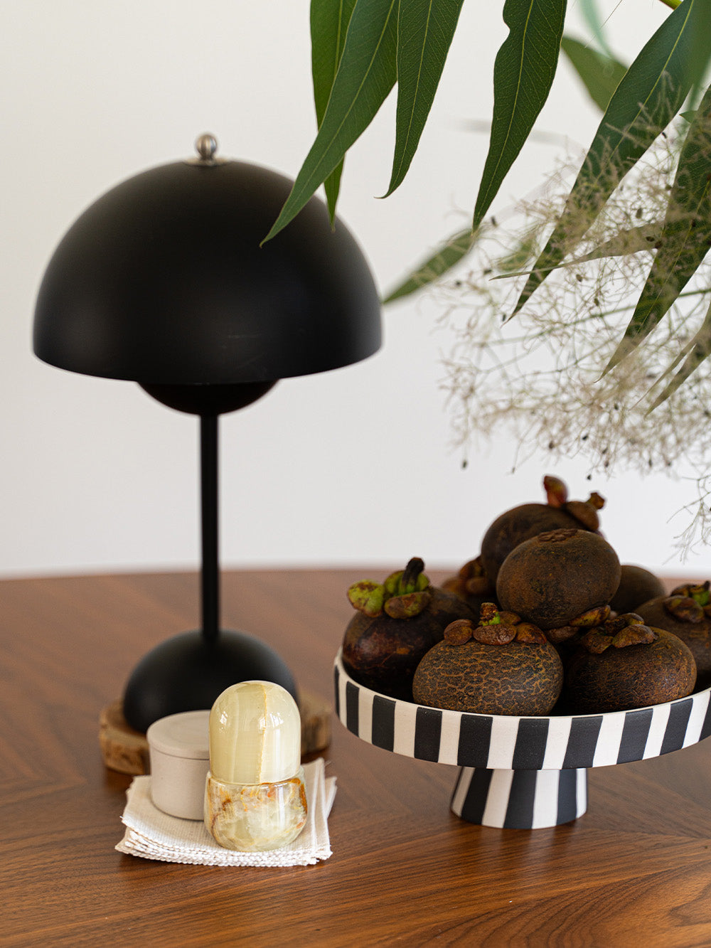 Close up of home decor featuring Satulight tablelamp and its complimentary home decor