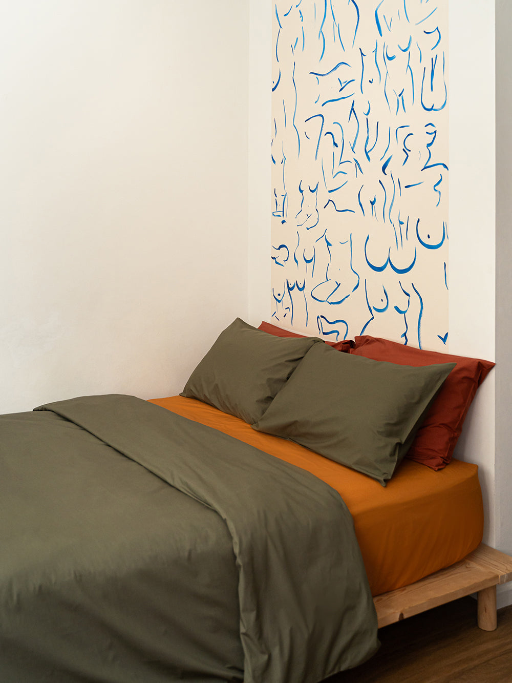 Painting in bedroom with Olive and Mustard Bedsheets