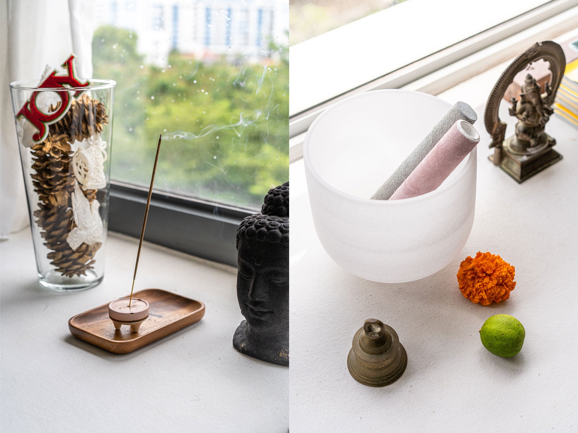 incense lighted next to buddha head, prayer bell and ganesha