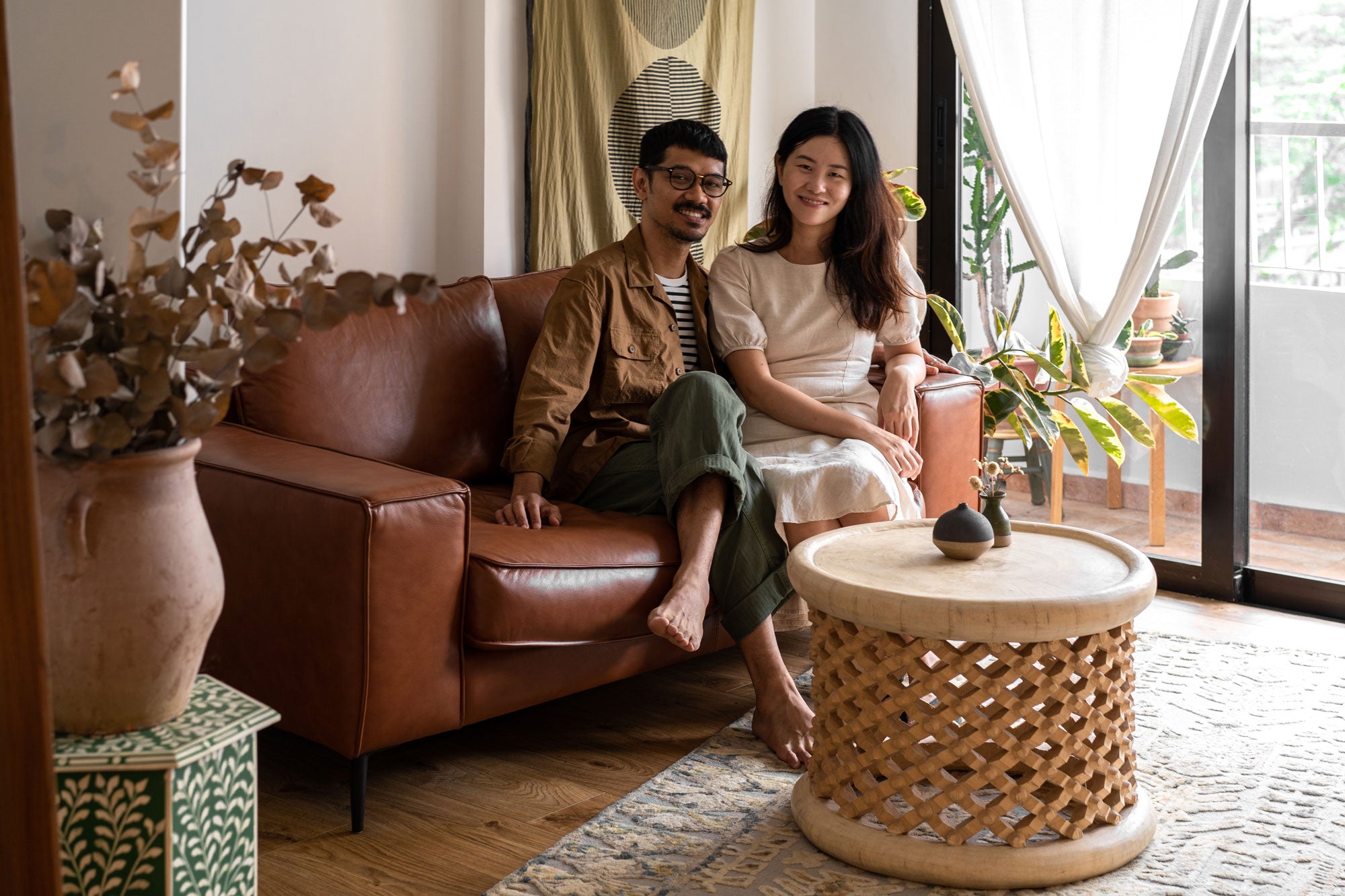 Singaporean couple sitting in 4 room hdb flat