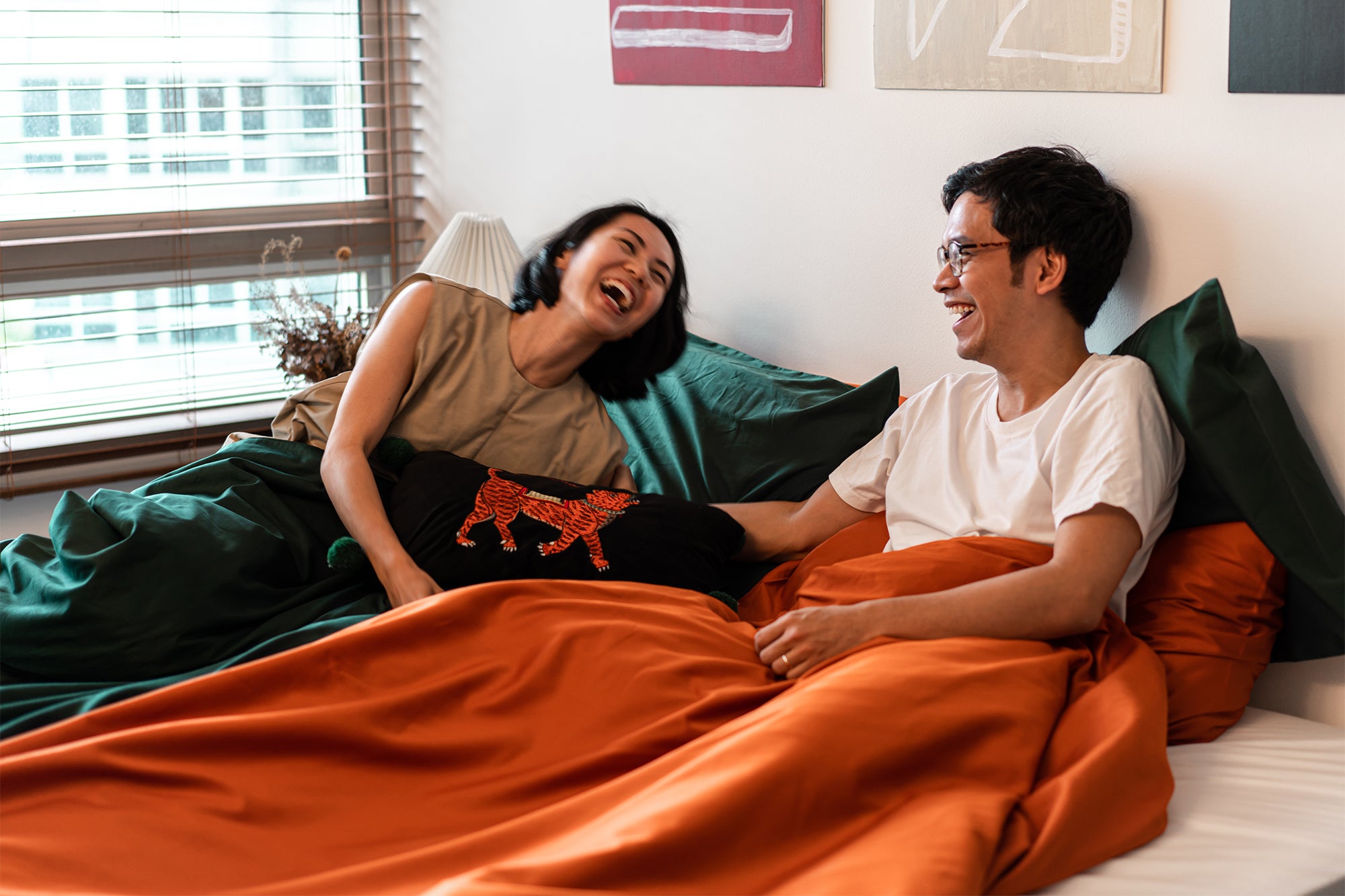 couple laughing in bedroom