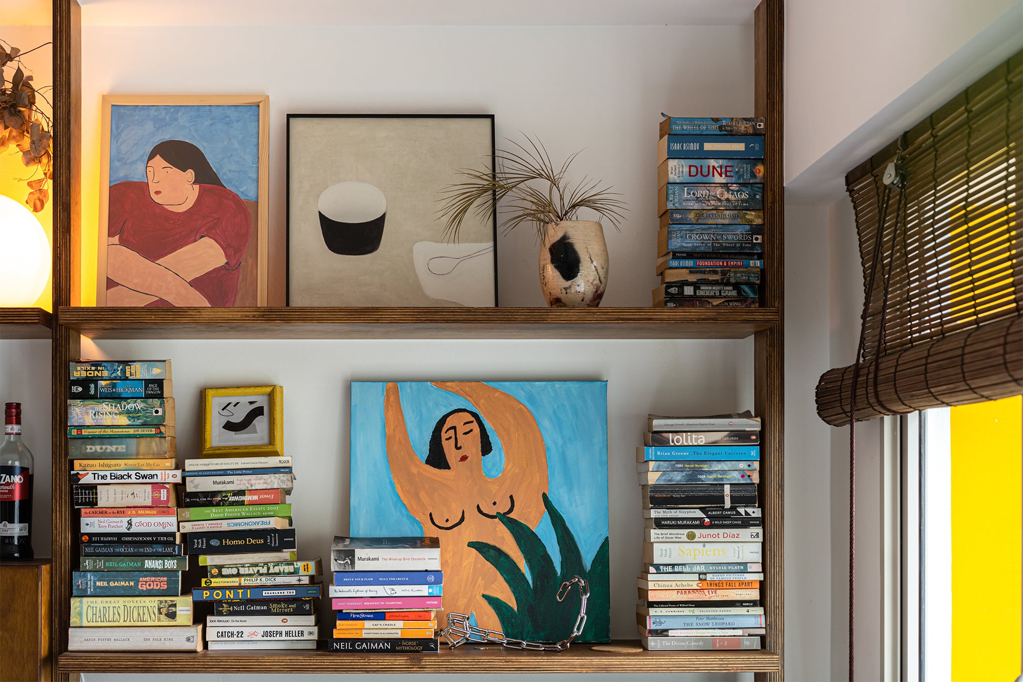 custom wooden shelf with books and paintings