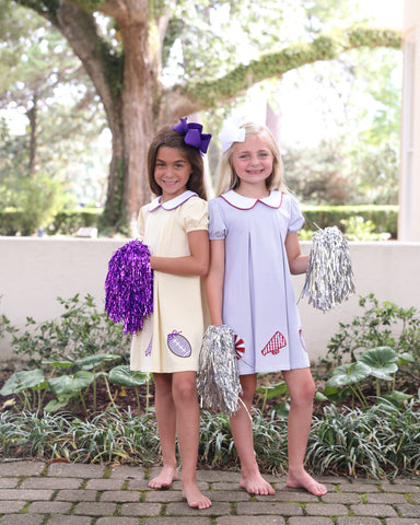 Jellybean by Smock Candy has the sweetest Pleat Dress in your teams colors.