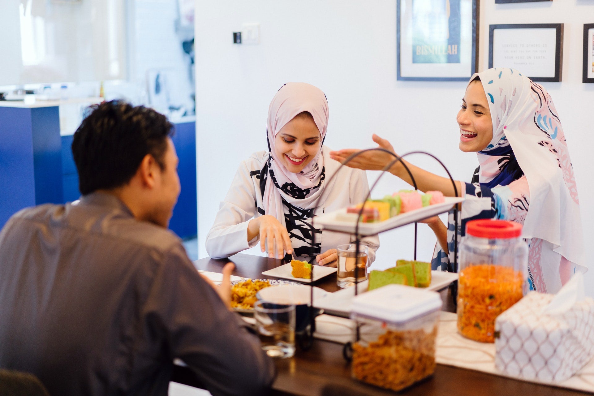 A group of friends laughing while enjoying a meal together