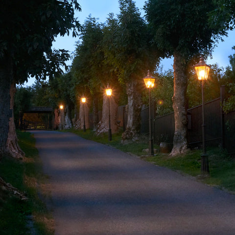 A driveway lined with post lights down the right hand side