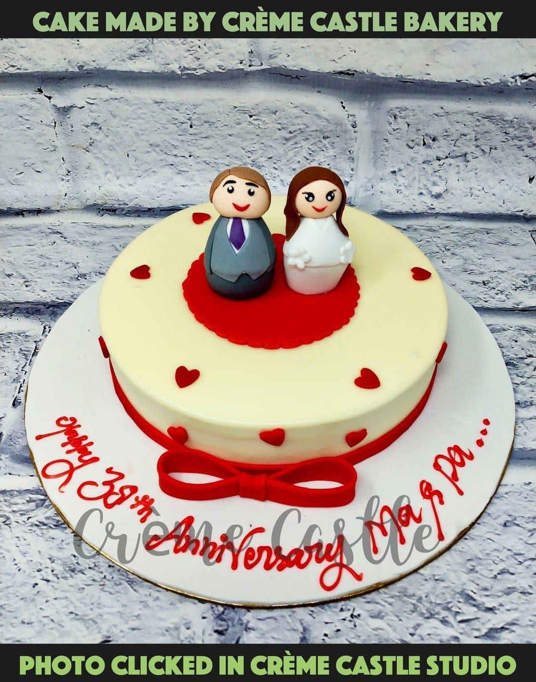 A cute cake for anniversary where caricatures of cute couple is ...