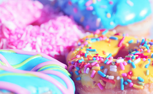 Rainbow colorful doughnuts with sprinkles and frosting