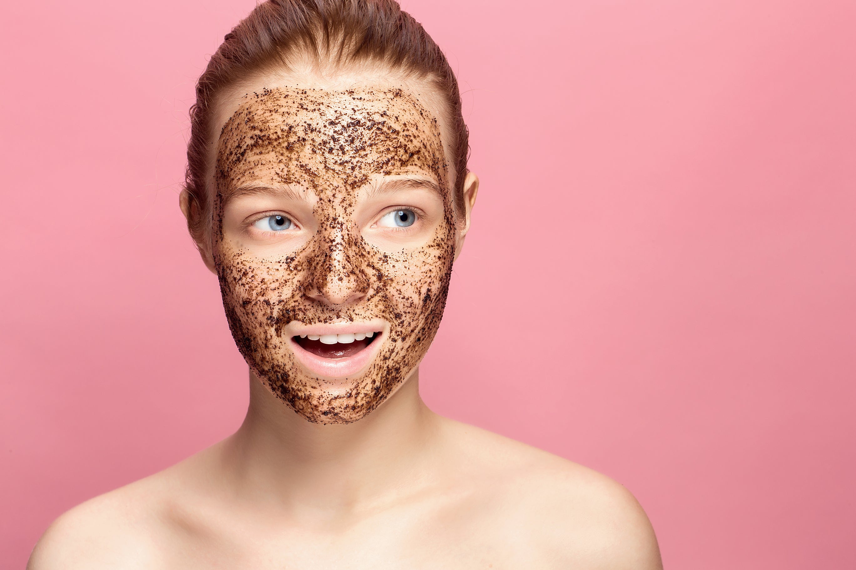 A pregnant woman applies a homemade coffee scrub to her face to exfoliate her skin naturally
