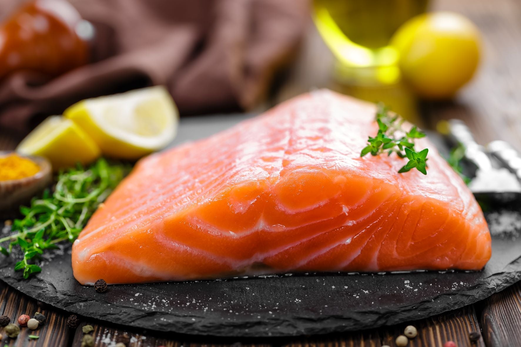 Salmon on a plate with herbs and lemon slices. Salmon is good for babies. 