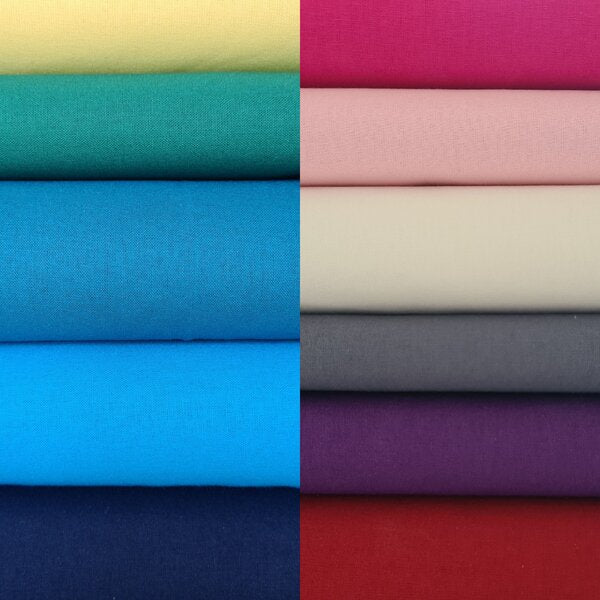 Photo of a stack of different types of fabric