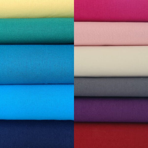 Photo showing a pile of different types of fabrics