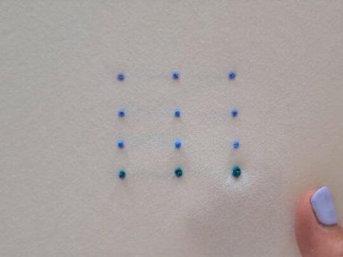 Embroidered French Knots in blue and green on white background
