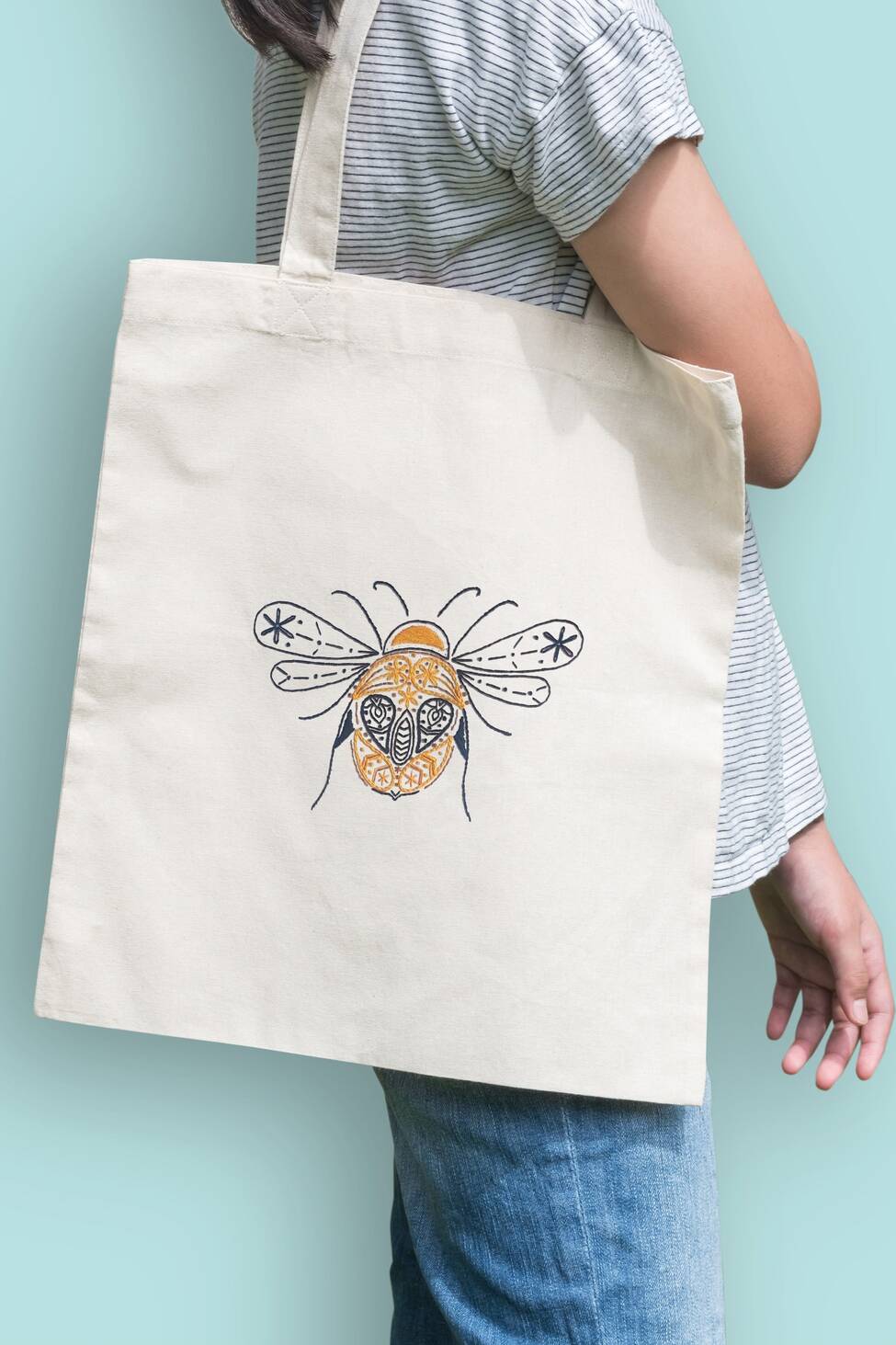 Organic and fairtrade tote bag with bee pattern embroidered on it