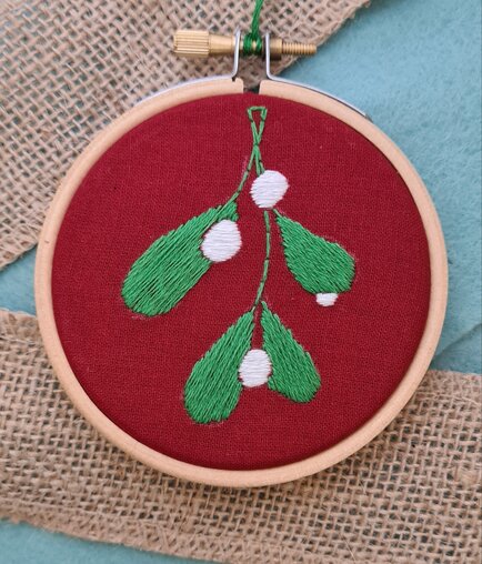 An embroidered mistletoe christmas bauble