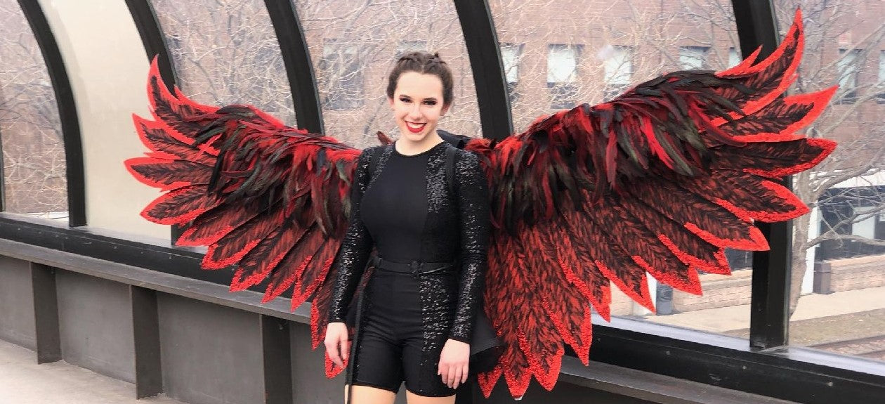 Photo of a young girl with finished product of automated wings