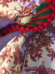 view of thickness of red and green tea cosy