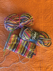 a sock cuff in multi-colored striped yarn