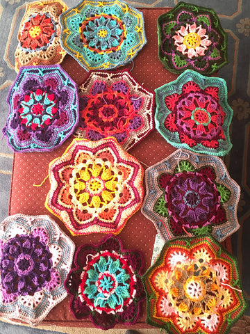 crocheted motifs for a blanket all laid out-color photo