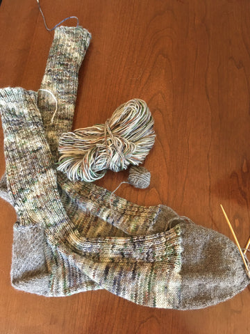 Green and gray variegated socks with gray toes and heel.