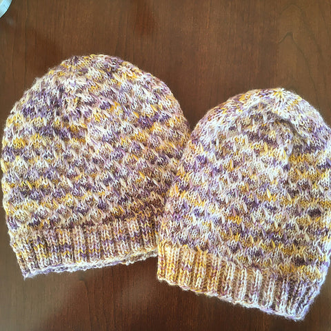 a pair of purple and yellow variegated Ice Time Hats