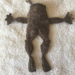brown knitted toad blocking on a towel