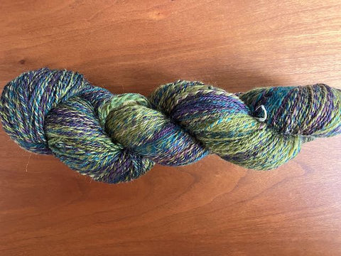 skein of handspun in a variegated green/blue/purple color way