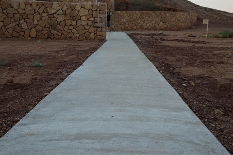 Finished concrete glowing pathway in the daytime.