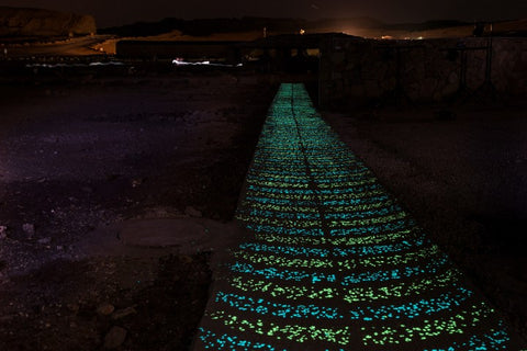 Glowing concrete pathway at night using 1/2" (12-14mm) AGT™ Emerald Yellow and Aqua Blue Glow Stones.