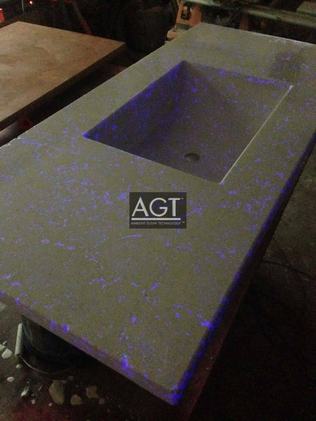 Glowing concrete bathroom vanity using AGT™ Plasma Purple Fine Glow Sand.