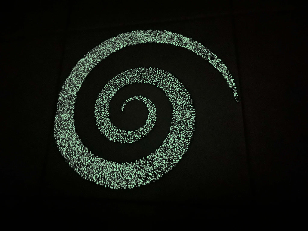 Glowing spiral pool design close up at night