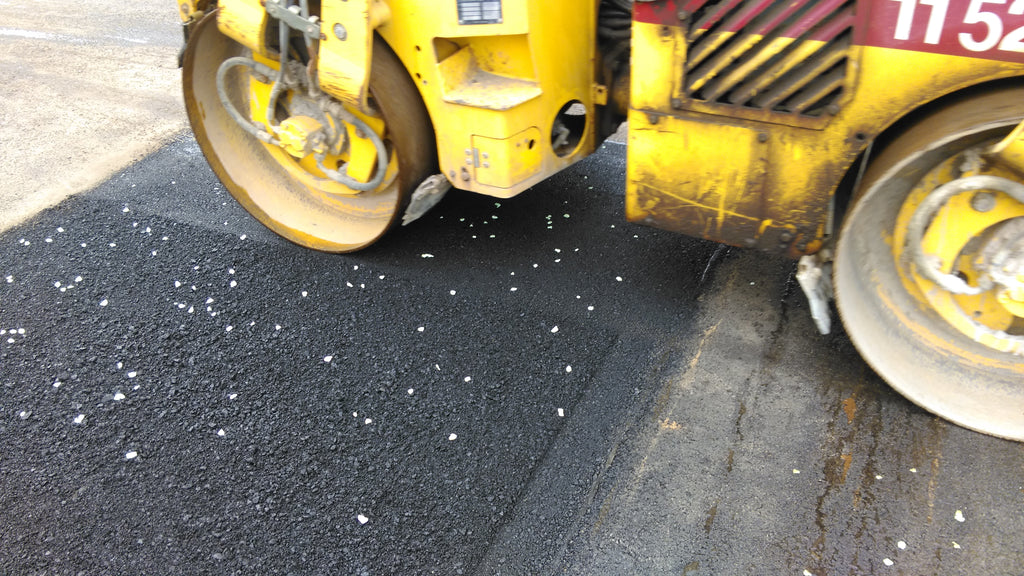 Rolling AGT commercial grade glow stones into asphalt 