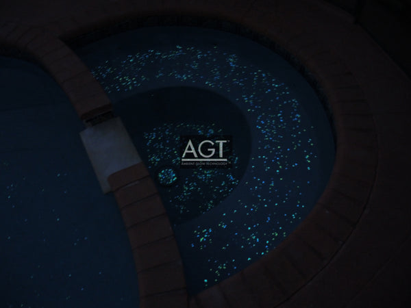 Glowing pool spa Powered by 1/2" Emerald Yellow AGT™ ULTRA Glow Stone. Seeded on and then polished. Night time view