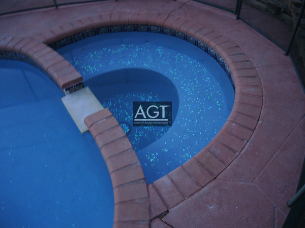 Glowing pool spa Powered by 1/2" Emerald Yellow AGT™ ULTRA Glow Stone. Seeded on and then polished. Day time view.