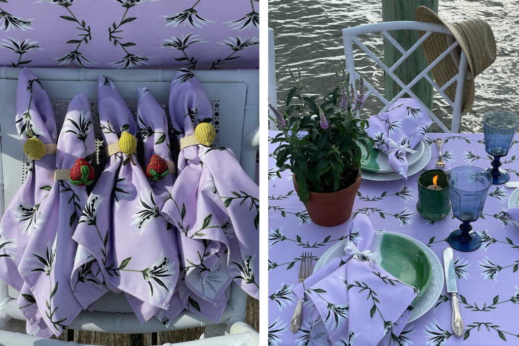 Close up of lavender floral napkins and tablecloths styled with green and purple plants