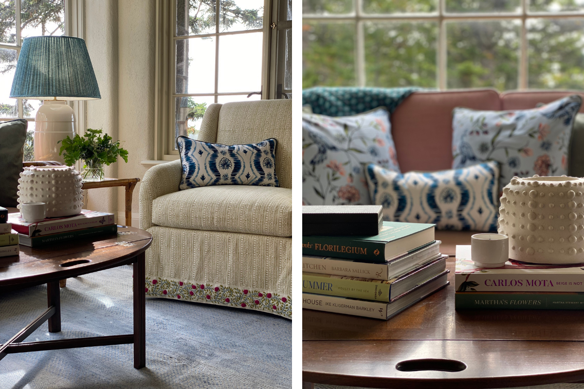 Living room styled with two Daphne powder custom pillows and one Blue Ikat Lumbar Pillow over coffee table stacked with books