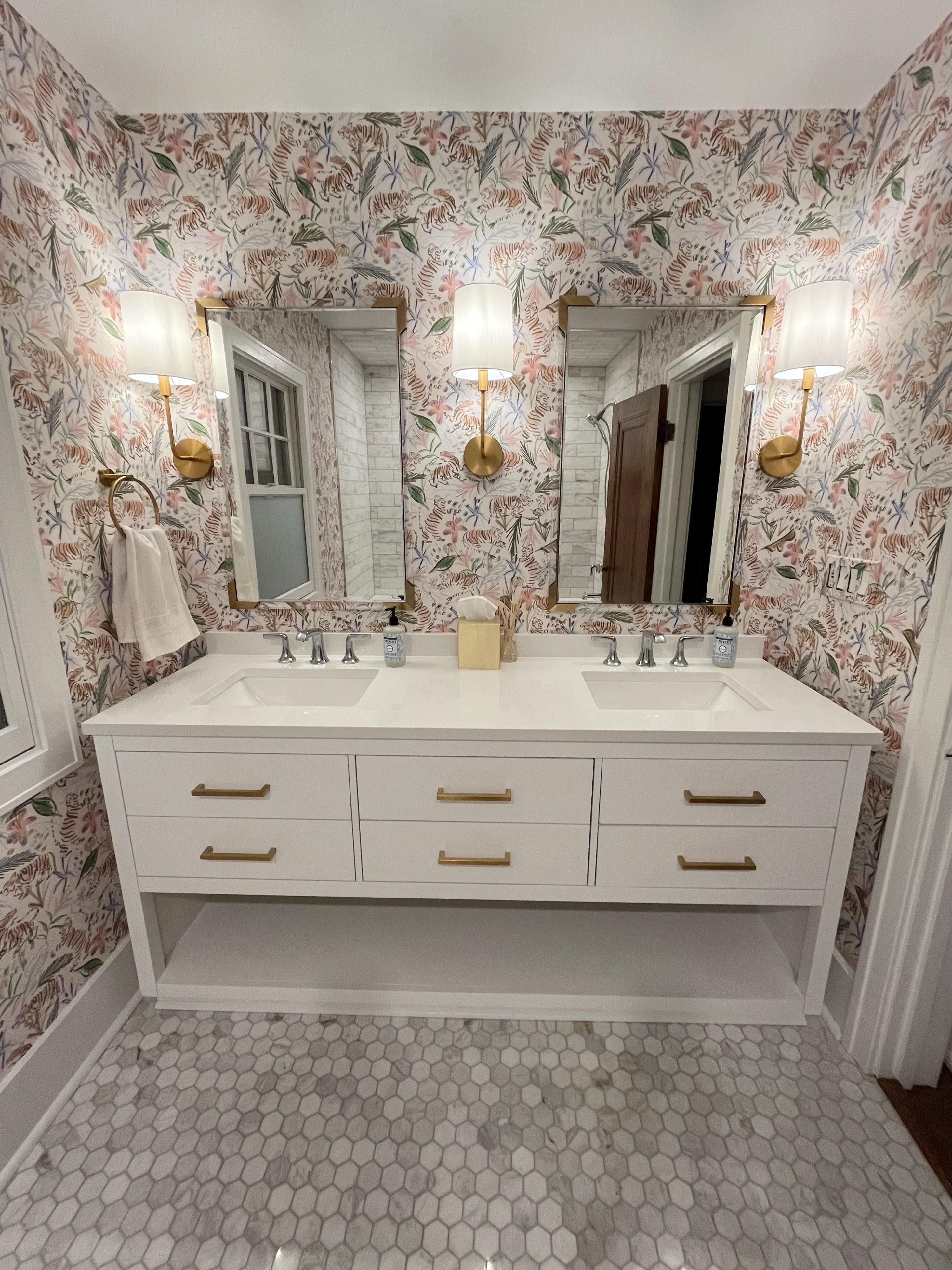 Bathroom with pink chinoiserie tiger wallaper and large white vanity