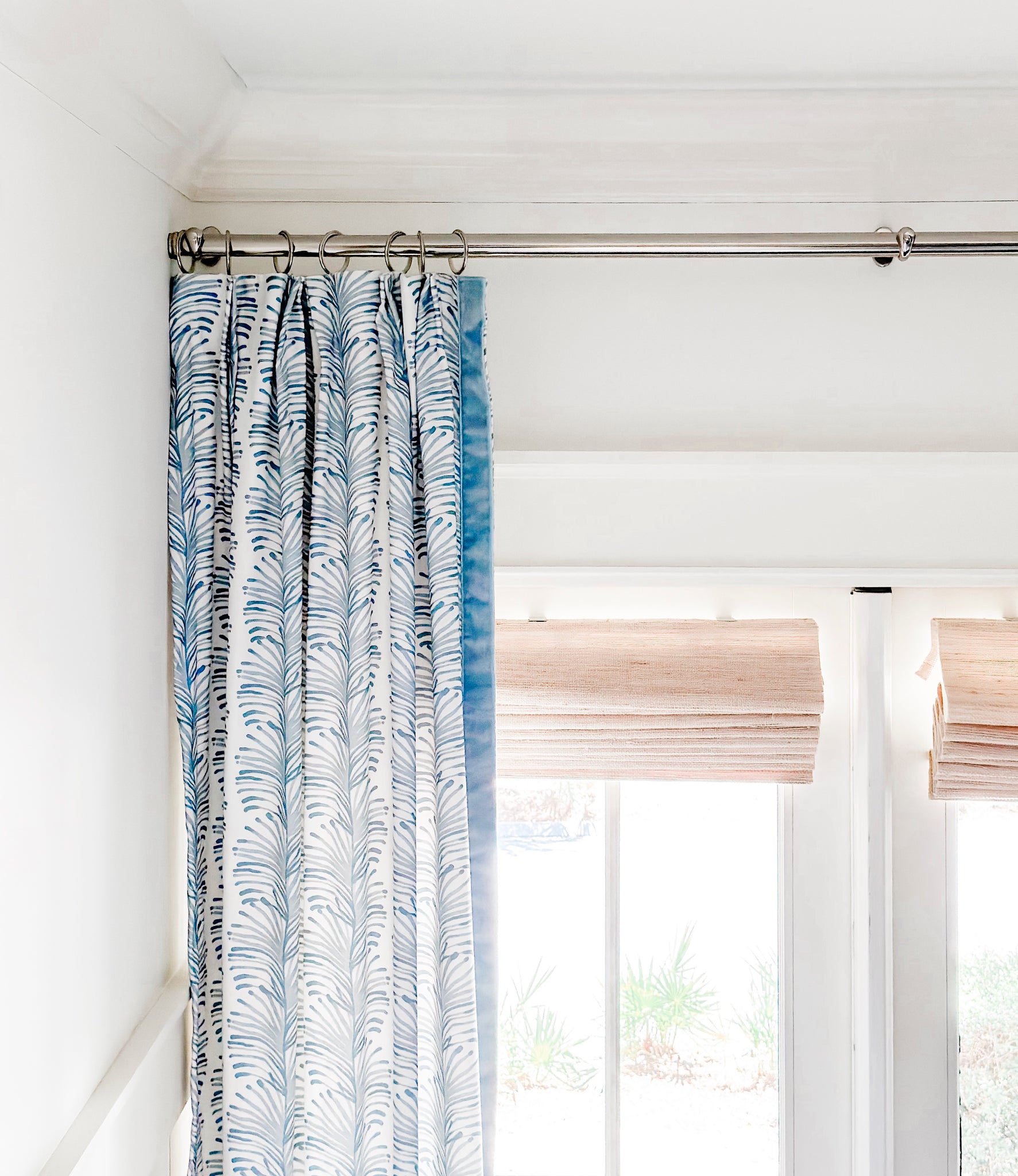 Illuminated window with Sky Blue Botanical Stripe custom curtain hanging on metal rod