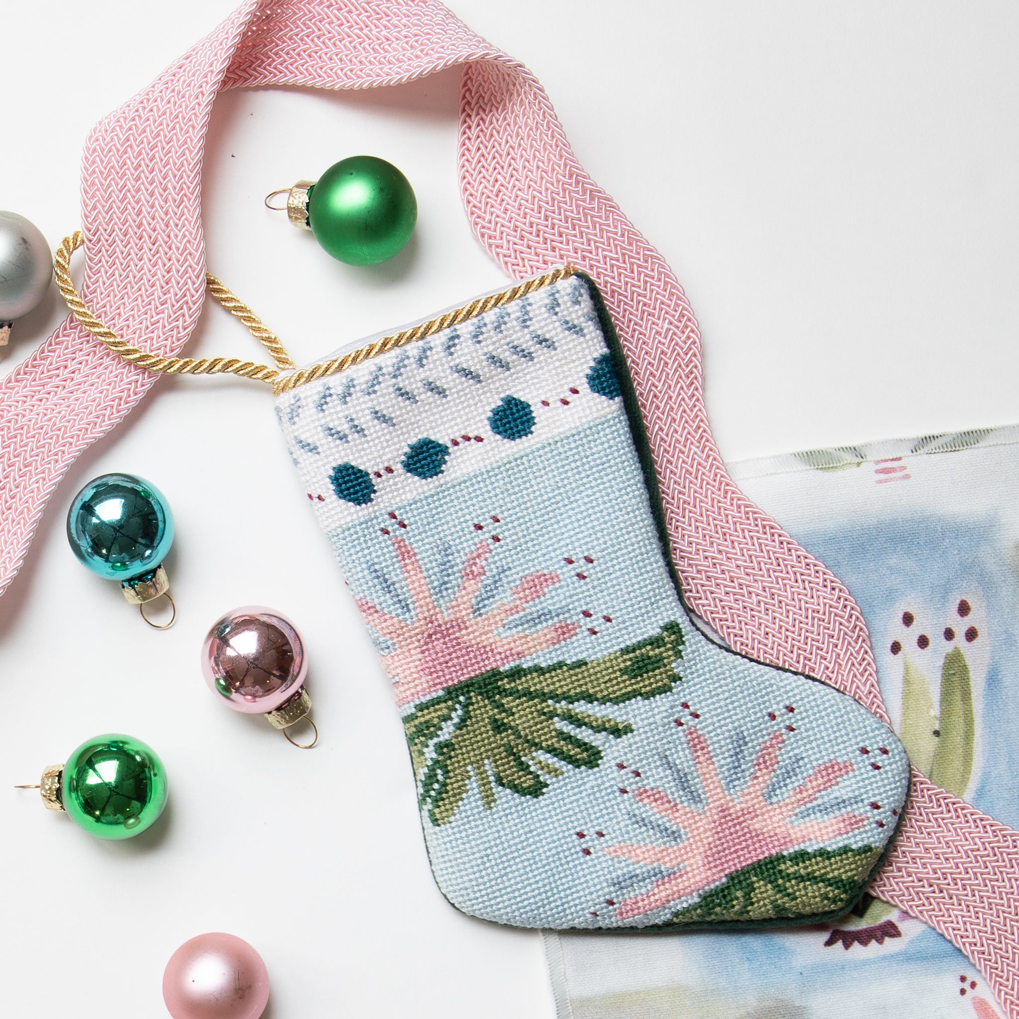 Pink blue and green mini stocking ornament styled with pink peony rick rack trim and mini ball ornaments