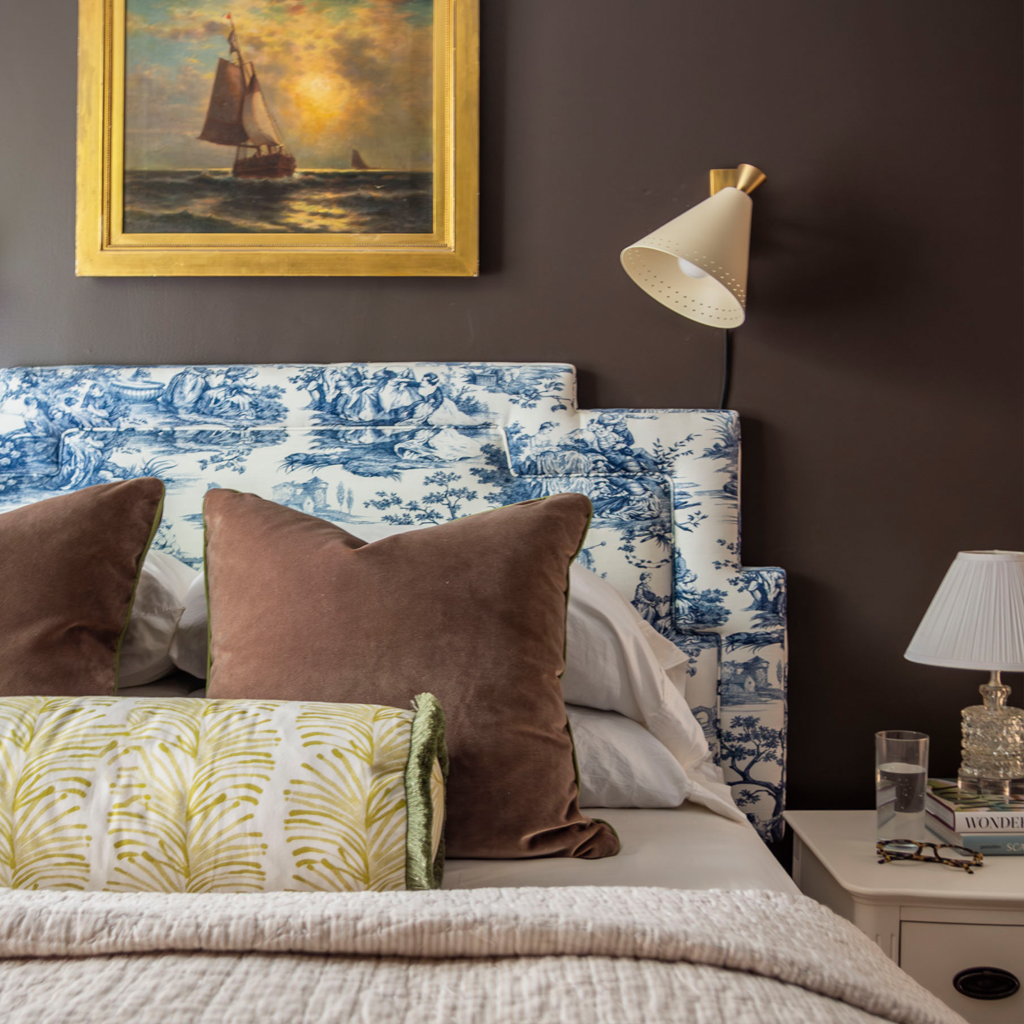 Bed close-up styled with two brown velvet custom pillows and one Yellow Stripe Chartreuse custom bolster pillow