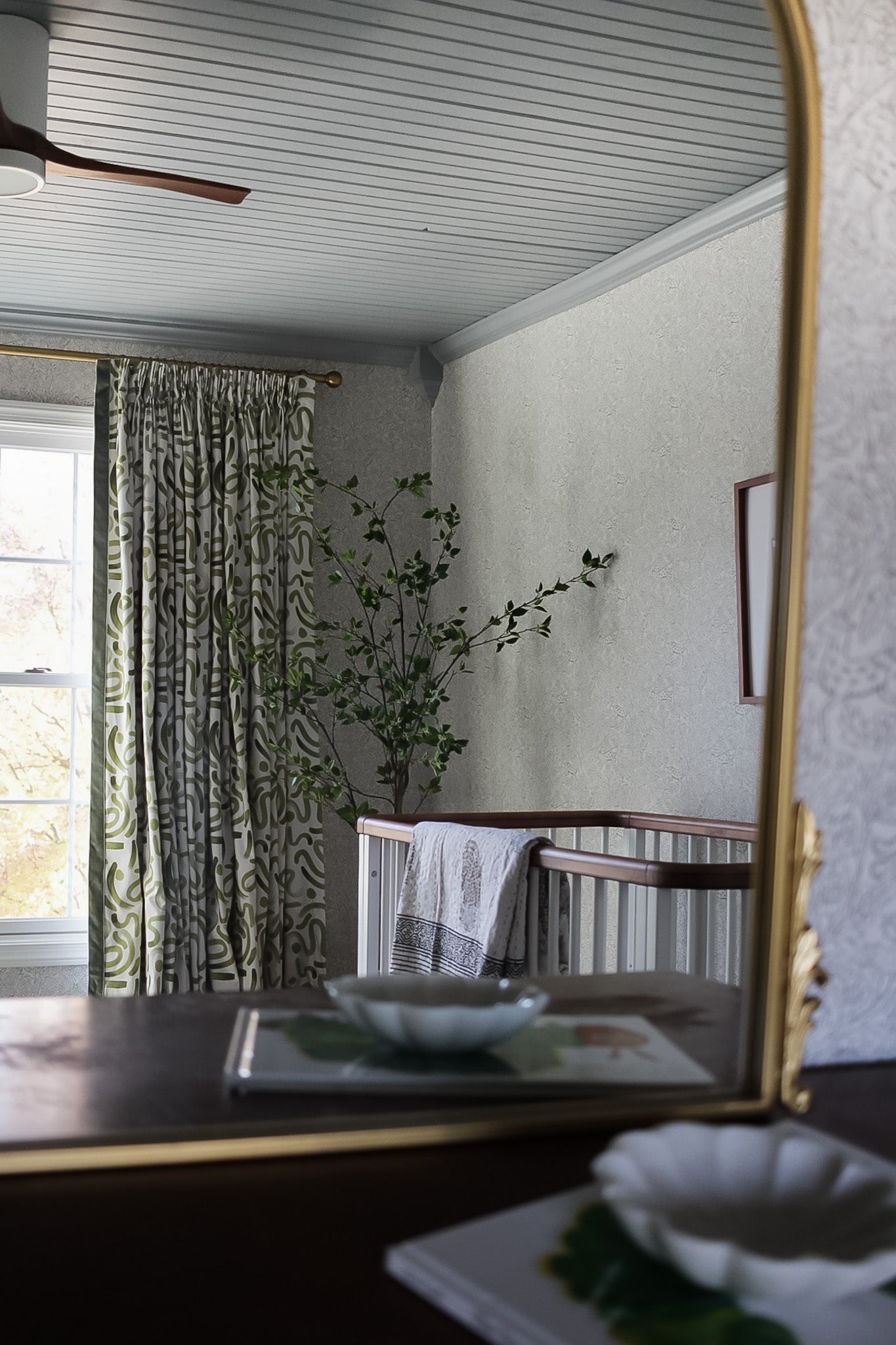 Mirror reflection of window with Moss Green custom curtains