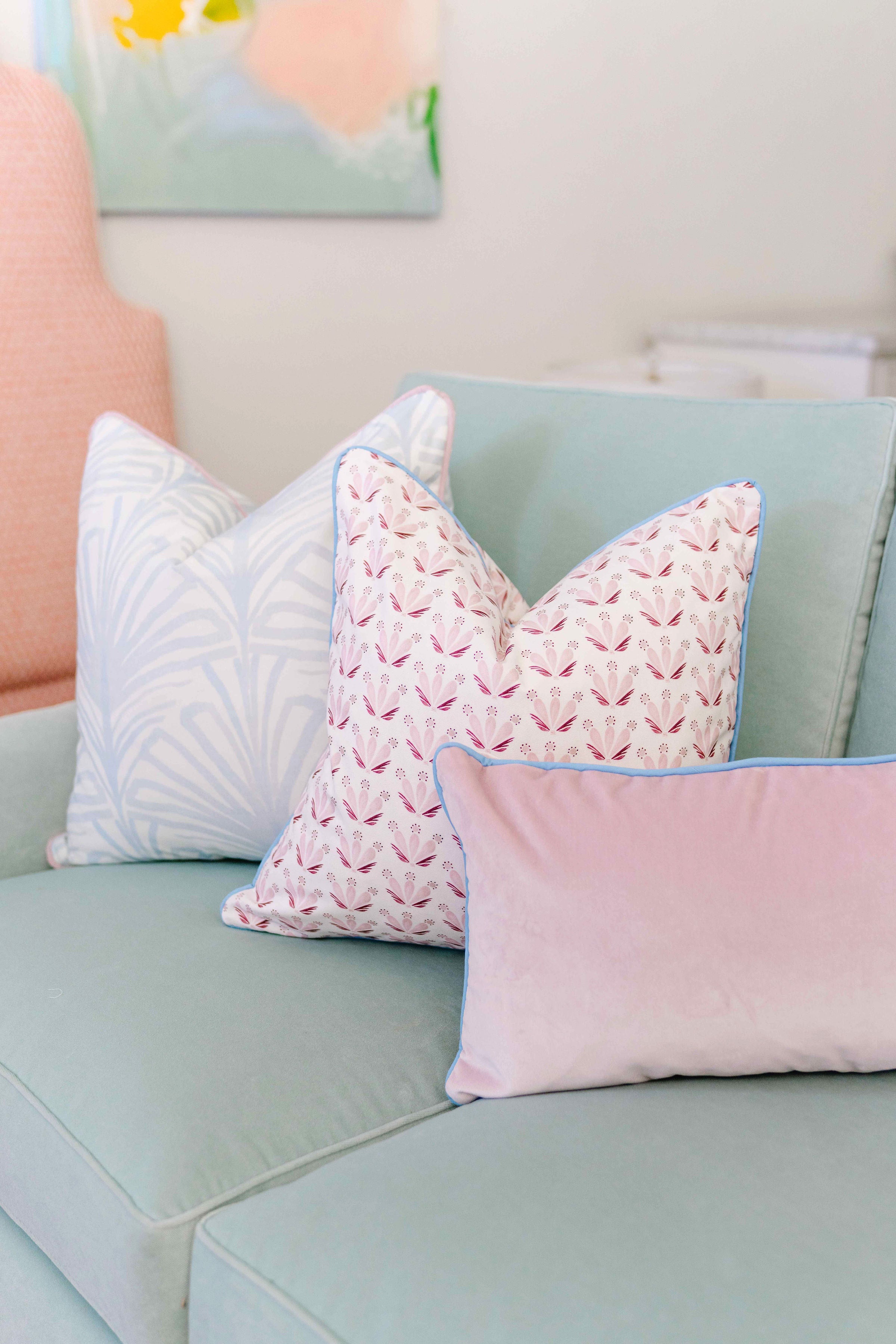 Blue Green Velvet Couch close-up with Sky Blue Botanical Stripe Custom Pillow, Pink & Burgundy Drop Repeat Floral Custom Pillow, and Pink Velvet Custom Lumbar