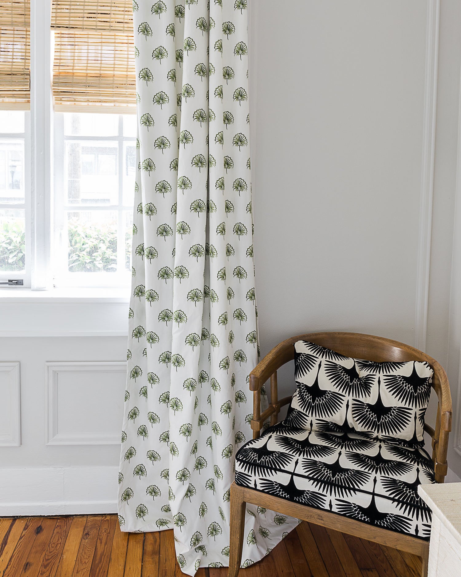 Bedroom corner with wooden chair next to illuminated window styled with Green Floral Custom Curtains