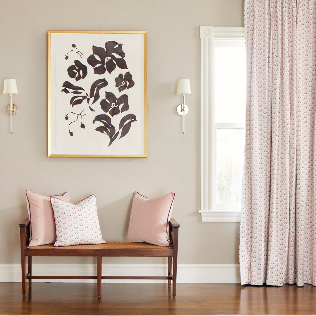 Pink & Burgundy Drop Repeat Floral custom curtain hanging on a window next to burgundy floral artwork and a wooden bench with white and pink custom pillows