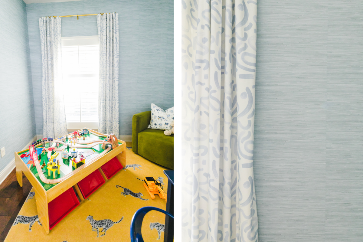 Kids playroom with sky blue grasscloth wallpaper and blue abstract custom curtains hanging in front of a window