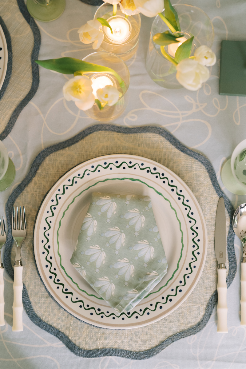 Placemat with white plate over and Blue & Green Floral Drop Repeat custom napkin on top