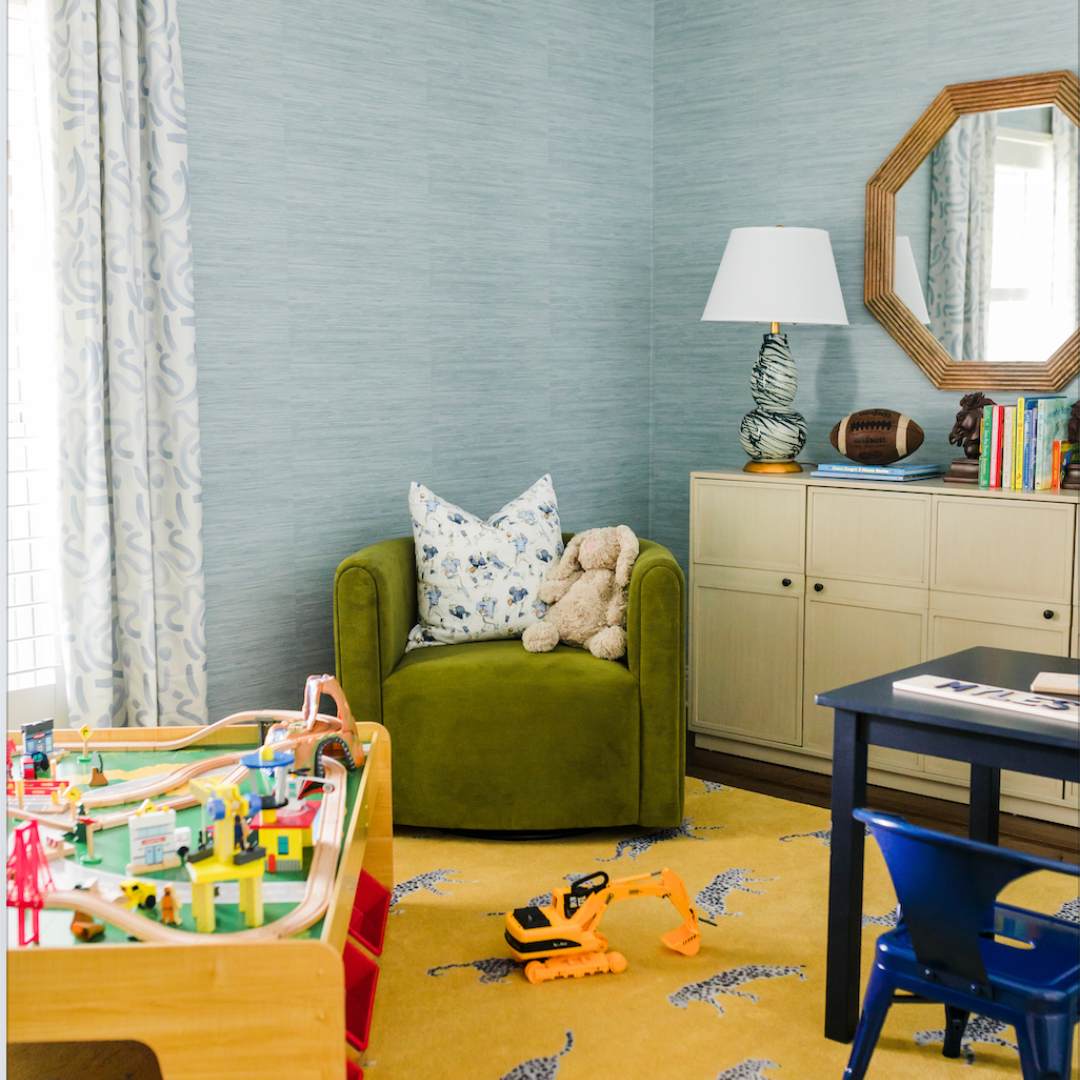 Kids playroom with sky blue grasscloth wallpaper and blue abstract custom curtains hanging in front of a window