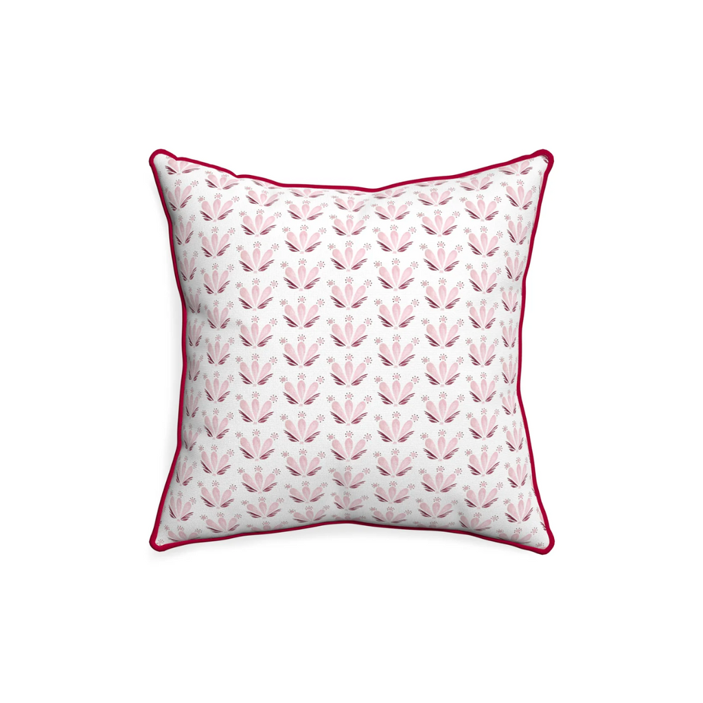 pink and maroon floral pillow on a white background