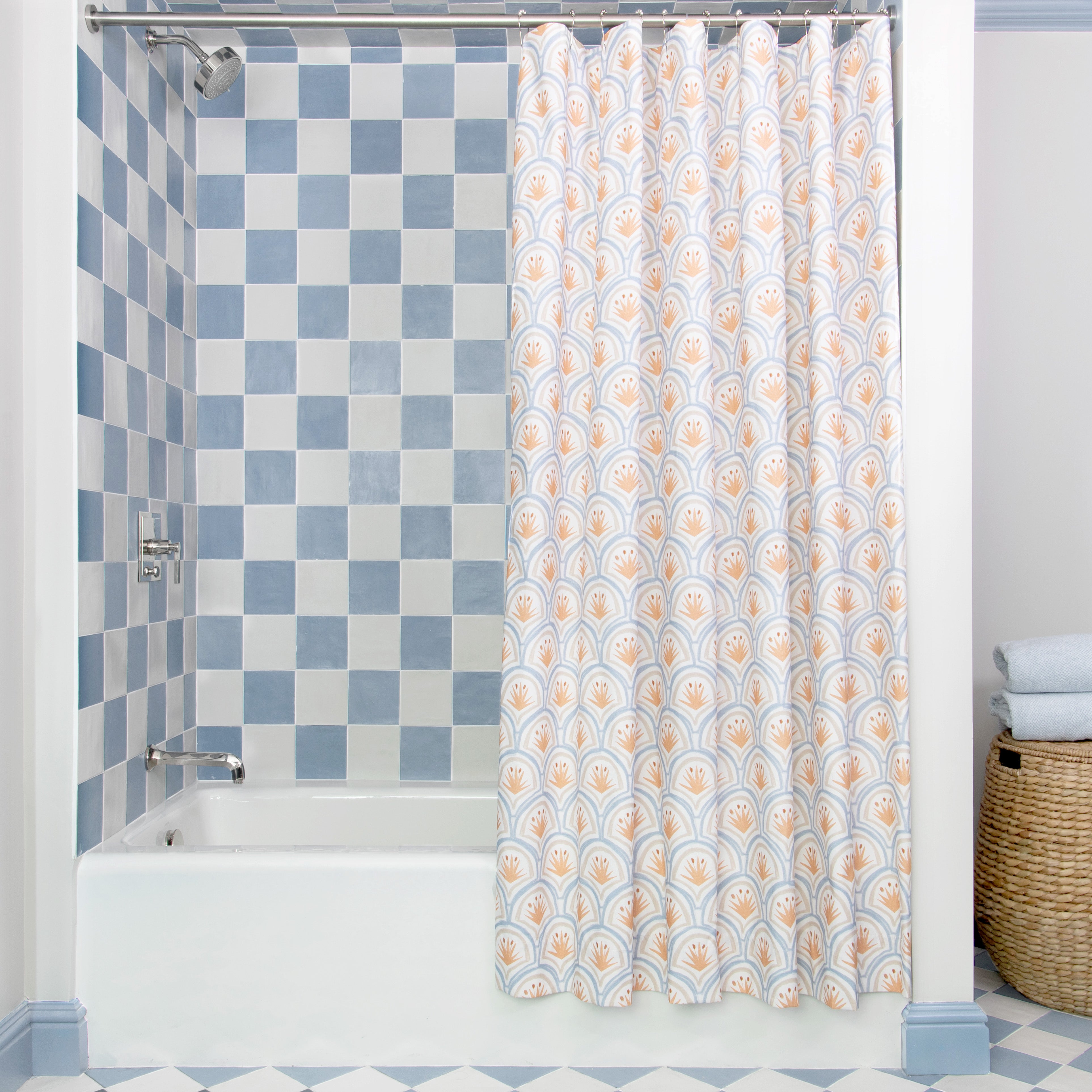 Art Deco Palm Pattern shower curtain hanging on rod in front of white tub in bathroom with blue and white tiles